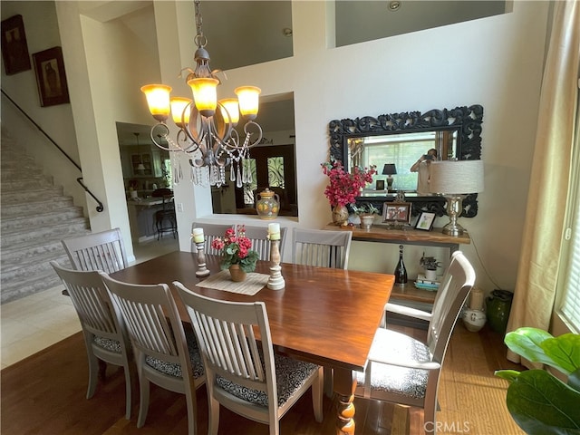 17 Thornbird, Aliso Viejo, CA 92656 - dining space with a chandelier, stairs, a high ceiling, and wood finished floors