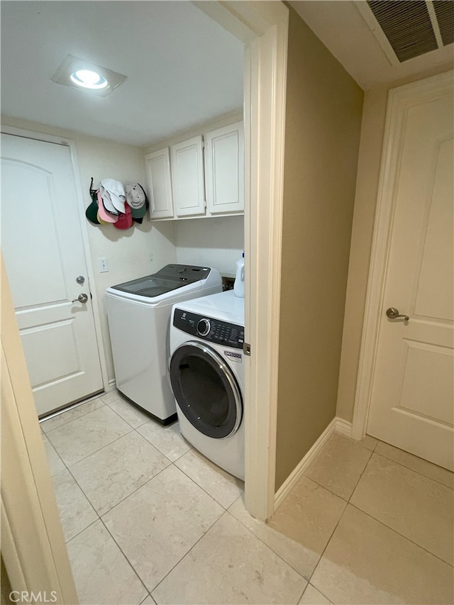 17 Thornbird, Aliso Viejo, CA 92656 - laundry area featuring washing machine and dryer, cabinet space, and light tile patterned floors