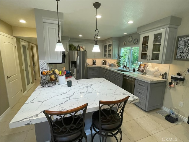 17 Thornbird, Aliso Viejo, CA 92656 - kitchen with appliances with stainless steel finishes, gray cabinets, decorative backsplash, recessed lighting, and a peninsula