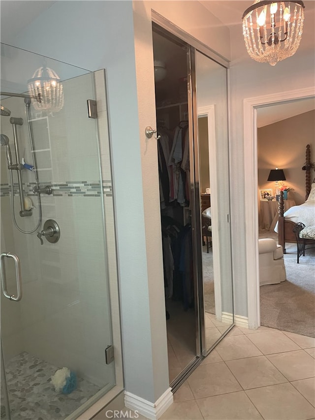 17 Thornbird, Aliso Viejo, CA 92656 - bathroom with a chandelier, connected bathroom, a shower stall, tile patterned flooring, and a walk in closet