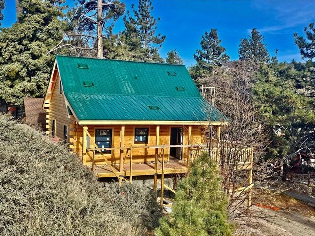 33149 Holcomb Creek Dr, Green Valley Lake, CA 92341 - rear view of house featuring a porch, log exterior, and a metal roof