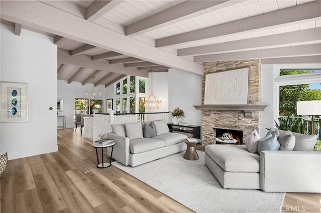 362 Vista Madera, Newport Beach, CA 92660 - living room featuring a chandelier, wood finished floors, and a stone fireplace