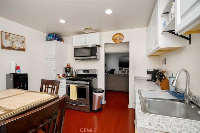 4220 W 165th St, Lawndale, CA 90260 - kitchen with stainless steel appliances, dark wood-type flooring, white cabinetry, light countertops, and recessed lighting