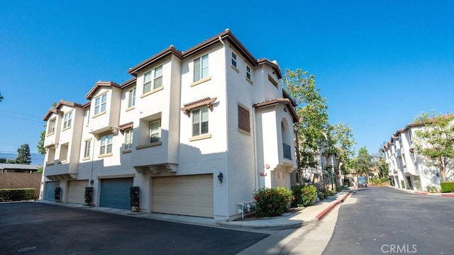 159 Principia Ct, Claremont, CA 91711 - view of building exterior with an attached garage, a residential view, and driveway