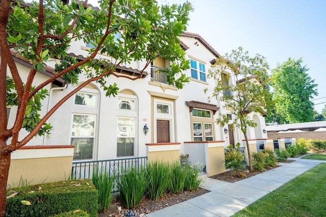 159 Principia Ct, Claremont, CA 91711 - view of front of house with stucco siding, a fenced front yard, and a balcony