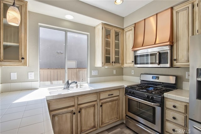 41808 Vardon Dr, Temecula, CA 92591 - kitchen featuring appliances with stainless steel finishes, glass insert cabinets, tile counters, and recessed lighting