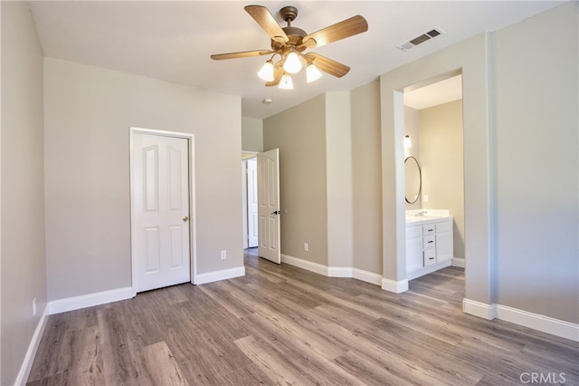 41808 Vardon Dr, Temecula, CA 92591 - unfurnished bedroom featuring wood finished floors, connected bathroom, and ceiling fan