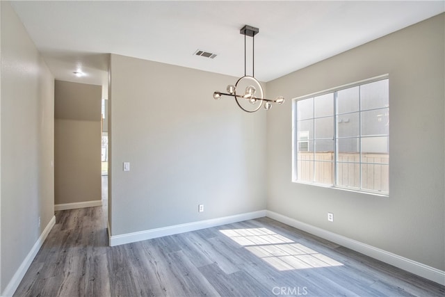 41808 Vardon Dr, Temecula, CA 92591 - unfurnished room featuring wood finished floors and a chandelier