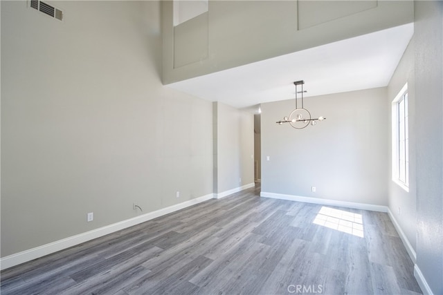 41808 Vardon Dr, Temecula, CA 92591 - empty room with wood finished floors and a chandelier