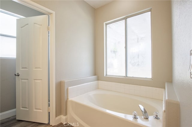 41808 Vardon Dr, Temecula, CA 92591 - bathroom with plenty of natural light, a bath, and wood finished floors