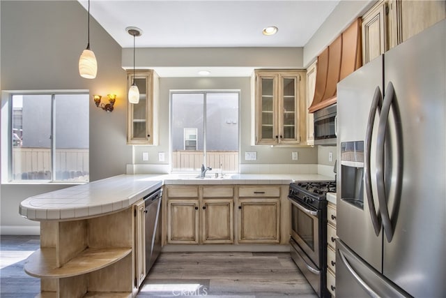 41808 Vardon Dr, Temecula, CA 92591 - kitchen featuring appliances with stainless steel finishes, tile counters, open shelves, a peninsula, and light wood-type flooring