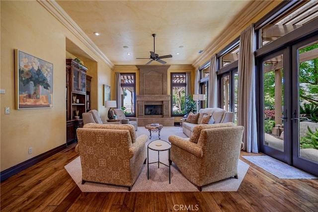 2882 Trovare Ct, Merced, CA 95340 - living room featuring plenty of natural light, french doors, ceiling fan, a large fireplace, and ornamental molding