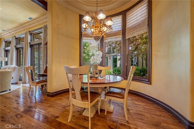 2882 Trovare Ct, Merced, CA 95340 - dining area with a chandelier, crown molding, and hardwood / wood-style flooring