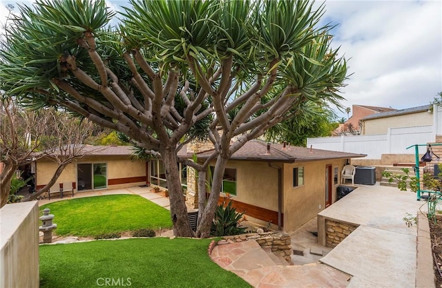 4510 S Mullen Ave, View Park, CA 90043 - rear view of property featuring a patio area and stucco siding