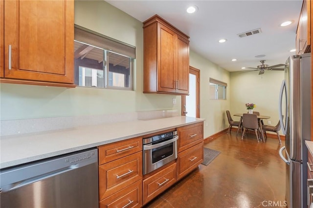 4510 S Mullen Ave, View Park, CA 90043 - kitchen featuring stainless steel appliances, recessed lighting, a ceiling fan, brown cabinetry, and light countertops