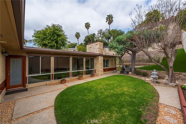 4510 S Mullen Ave, View Park, CA 90043 - view of grassy yard with a sunroom and a patio area