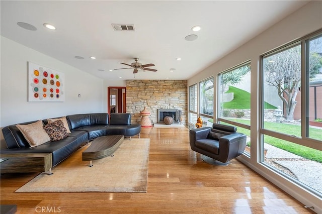 4510 S Mullen Ave, View Park, CA 90043 - living area featuring healthy amount of natural light, a stone fireplace, light wood finished floors, and recessed lighting