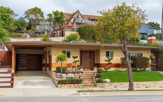 4510 S Mullen Ave, View Park, CA 90043 - view of front of house featuring concrete driveway, stucco siding, and a front yard
