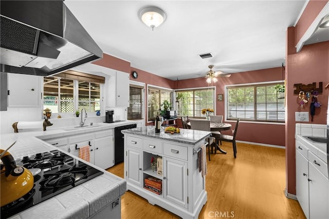 1210 W Marshall Blvd, San Bernardino, CA 92405 - kitchen featuring exhaust hood, black appliances, tile counters, and white cabinetry