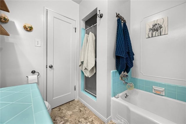 1210 W Marshall Blvd, San Bernardino, CA 92405 - full bathroom with a garden tub and baseboards