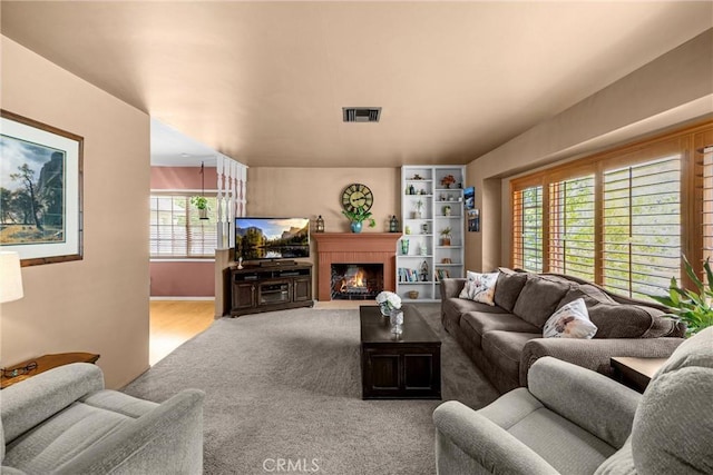 1210 W Marshall Blvd, San Bernardino, CA 92405 - living area with carpet flooring and a lit fireplace