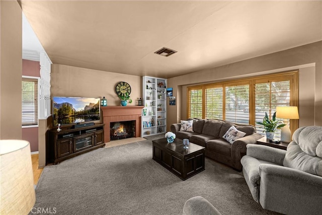 1210 W Marshall Blvd, San Bernardino, CA 92405 - carpeted living room featuring plenty of natural light and a fireplace with flush hearth
