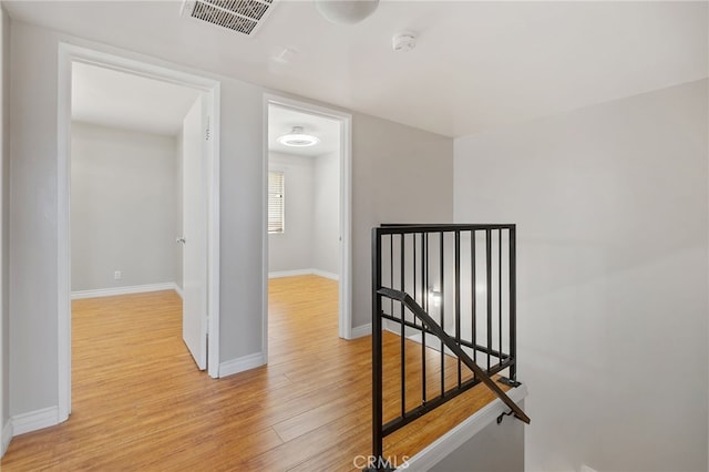 2621 E 20th St Unit 12, Signal Hill, CA 90755 - hallway featuring light wood-style flooring and an upstairs landing