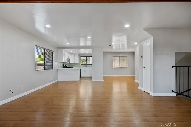 2621 E 20th St Unit 12, Signal Hill, CA 90755 - unfurnished living room featuring light wood-style floors, healthy amount of natural light, and recessed lighting