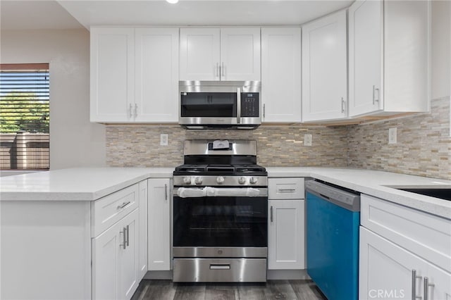 2621 E 20th St Unit 12, Signal Hill, CA 90755 - kitchen with appliances with stainless steel finishes, dark wood-style floors, light countertops, and white cabinets