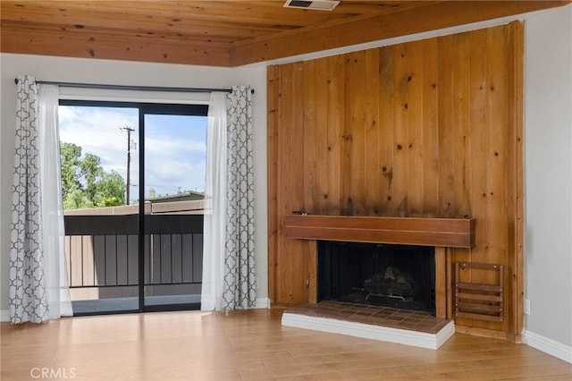 2621 E 20th St Unit 12, Signal Hill, CA 90755 - unfurnished living room with a fireplace, wooden ceiling, and wood finished floors