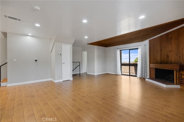 2621 E 20th St Unit 12, Signal Hill, CA 90755 - unfurnished living room featuring a fireplace, light wood-type flooring, a baseboard radiator, and recessed lighting