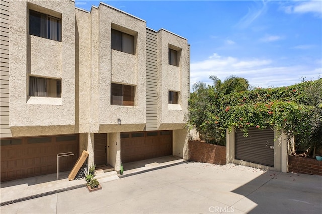 2621 E 20th St Unit 12, Signal Hill, CA 90755 - view of building exterior with a garage and concrete driveway