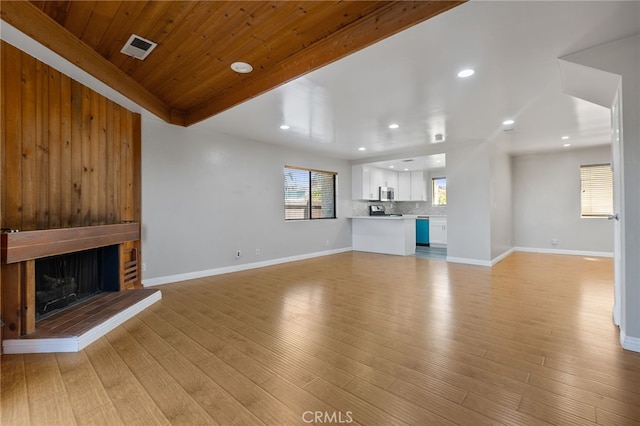 2621 E 20th St Unit 12, Signal Hill, CA 90755 - unfurnished living room with a fireplace, light wood-type flooring, recessed lighting, and wooden ceiling