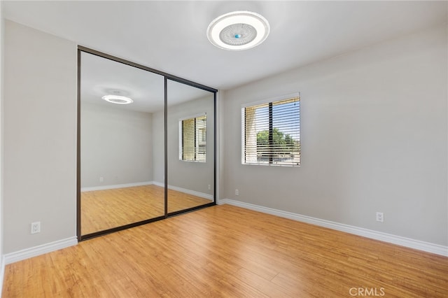2621 E 20th St Unit 12, Signal Hill, CA 90755 - unfurnished bedroom with wood finished floors and a closet