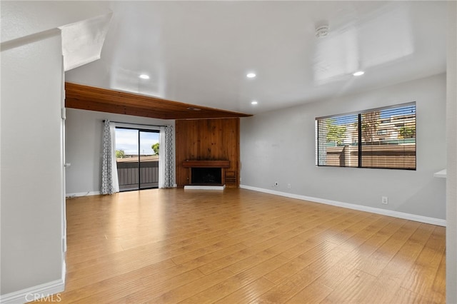2621 E 20th St Unit 12, Signal Hill, CA 90755 - unfurnished living room with recessed lighting, a fireplace, and light wood-style flooring