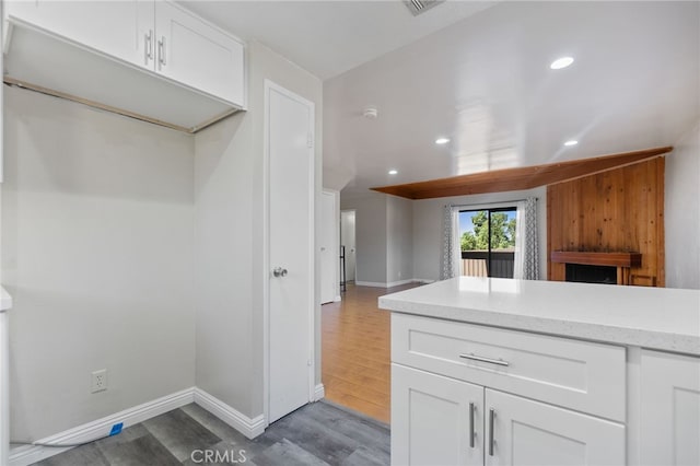 2621 E 20th St Unit 12, Signal Hill, CA 90755 - kitchen featuring white cabinets, light wood-style flooring, recessed lighting, a fireplace, and open floor plan
