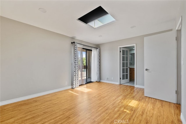 2621 E 20th St Unit 12, Signal Hill, CA 90755 - empty room featuring light wood-type flooring and a skylight
