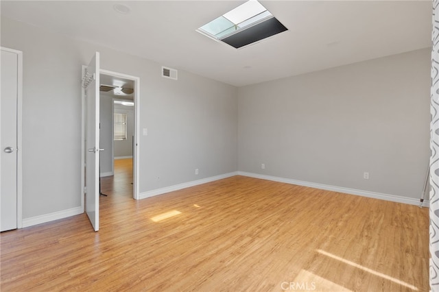 2621 E 20th St Unit 12, Signal Hill, CA 90755 - spare room featuring light wood-style floors and a skylight