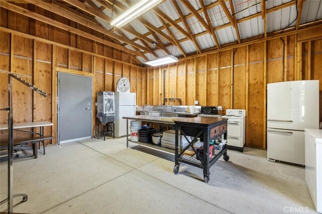 4742 Crow Rd, Oakdale, CA 95361 - miscellaneous room with concrete floors, vaulted ceiling, and a garage