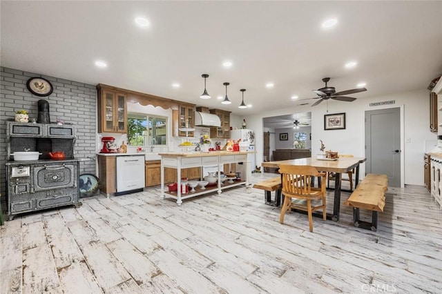 4742 Crow Rd, Oakdale, CA 95361 - dining area with light wood finished floors, ceiling fan, a wood stove, and recessed lighting