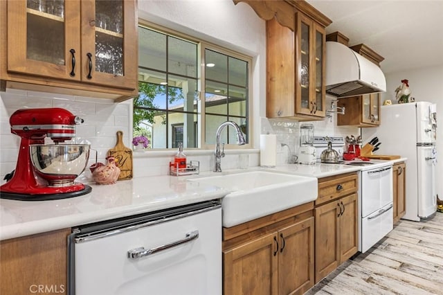 4742 Crow Rd, Oakdale, CA 95361 - kitchen featuring exhaust hood, white appliances, brown cabinets, and decorative backsplash