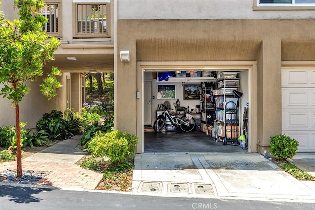 2 Daytona Unit 129, Laguna Niguel, CA 92677 - doorway to property with a garage and stucco siding