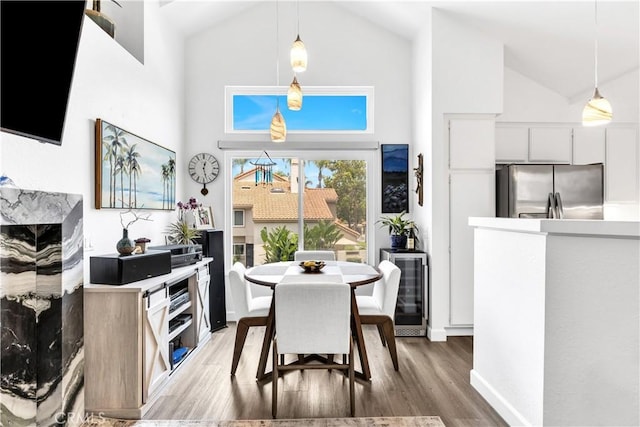 2 Daytona Unit 129, Laguna Niguel, CA 92677 - dining room featuring high vaulted ceiling, light wood-style flooring, and wine cooler
