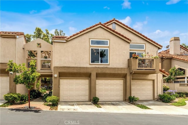 2 Daytona Unit 129, Laguna Niguel, CA 92677 - view of property with stucco siding, a garage, a balcony, and a tiled roof