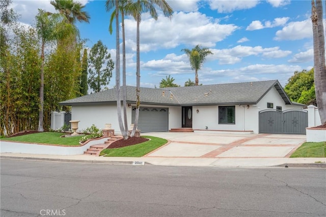 25981 Cordillera Dr, Mission Viejo, CA 92691 - ranch-style house with a gate, concrete driveway, an attached garage, stucco siding, and a shingled roof