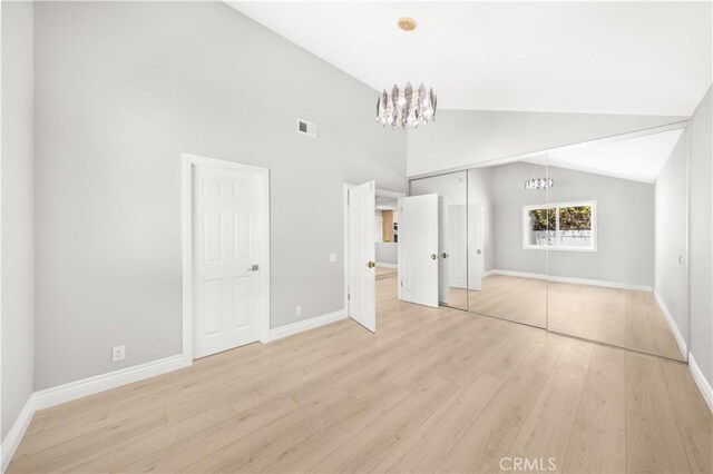 25981 Cordillera Dr, Mission Viejo, CA 92691 - unfurnished bedroom with a chandelier, light wood-type flooring, and vaulted ceiling
