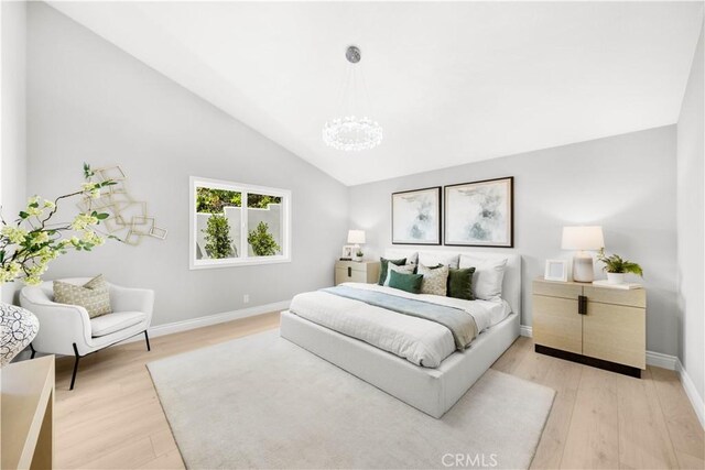 25981 Cordillera Dr, Mission Viejo, CA 92691 - bedroom with a chandelier, light wood finished floors, and lofted ceiling