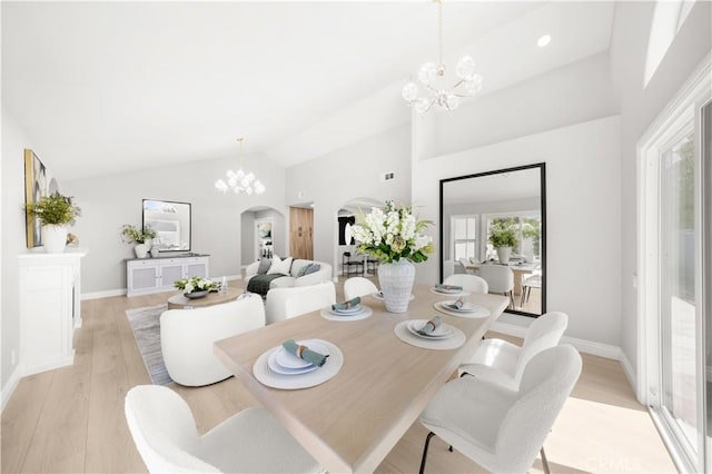 25981 Cordillera Dr, Mission Viejo, CA 92691 - dining area with arched walkways, a chandelier, high vaulted ceiling, and light wood-style flooring