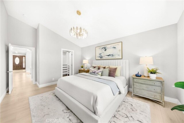 25981 Cordillera Dr, Mission Viejo, CA 92691 - bedroom featuring a chandelier, light wood-type flooring, and high vaulted ceiling