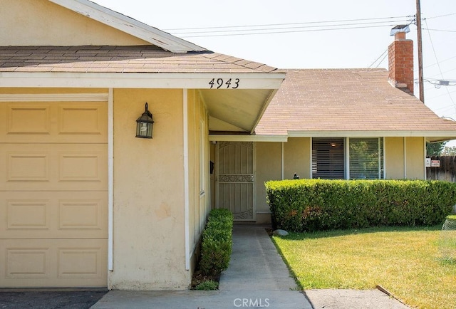 4943 Bresee Ave, Baldwin Park, CA 91706 - view of exterior entry with roof with shingles, an attached garage, a yard, and a chimney